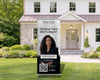 A Bentley McKay real estate advertisement is displayed in front of a house, promoting the idea of finding the right place to buy or sell a home.