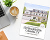 a brochure for a large two-story house in Columbia, Tennessee, with a laptop, coffee cup, and potted plant on a desk.